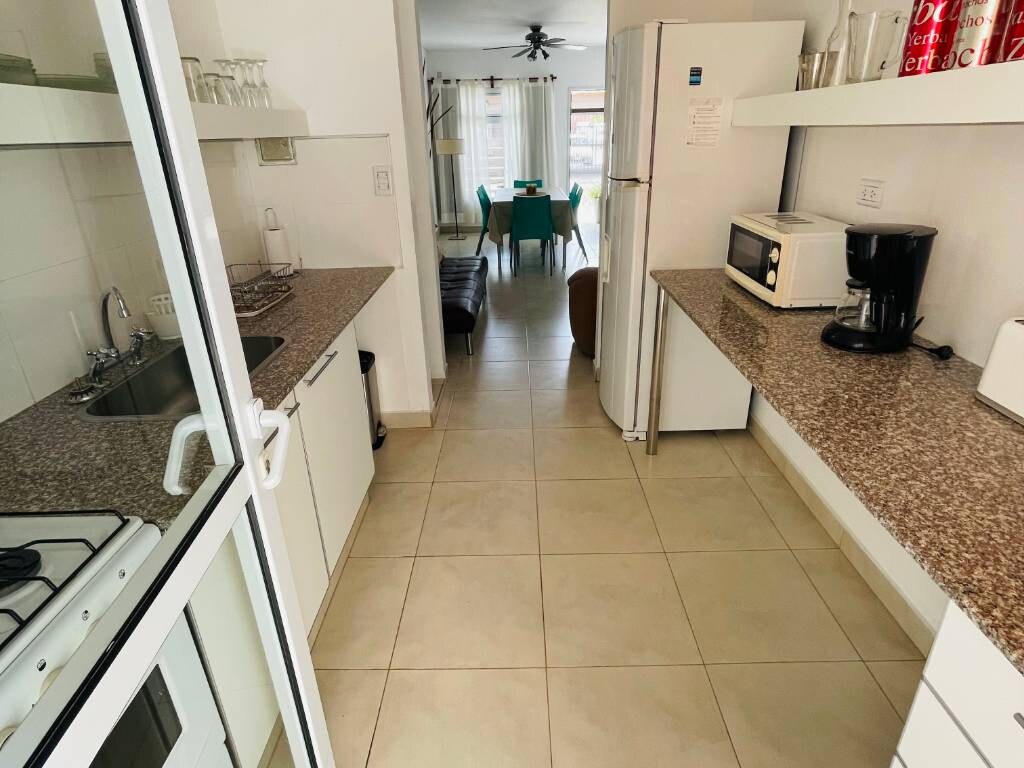 Kitchen with granite worktop, microwave, coffee maker and fridge