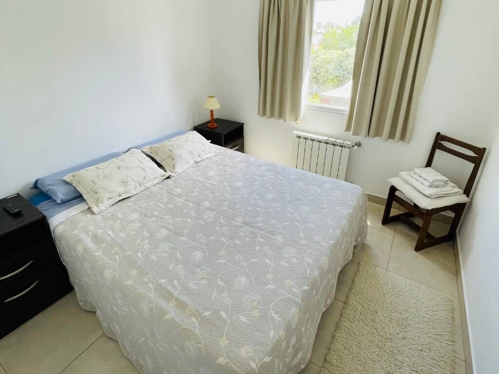 Double bed with embroidered white bedspread