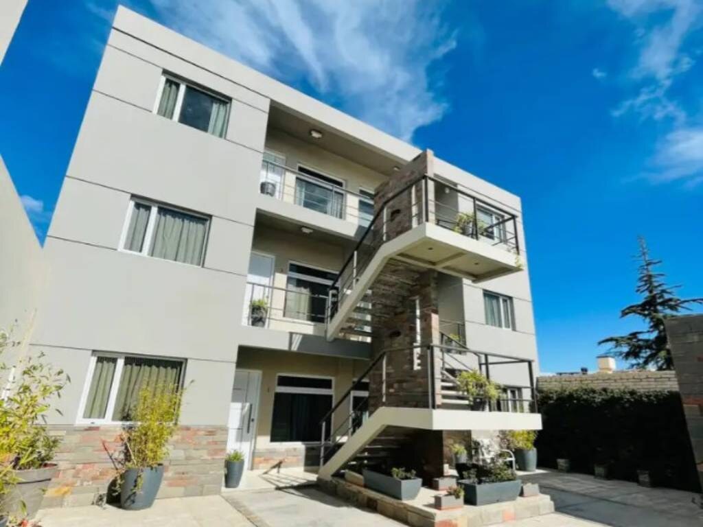 Front of the building with the outdoor staircase and blue sky