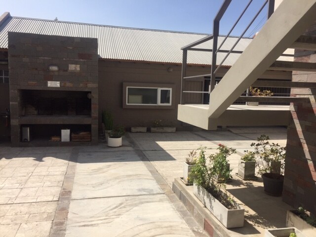 Brick barbecue grill at the back of the patio