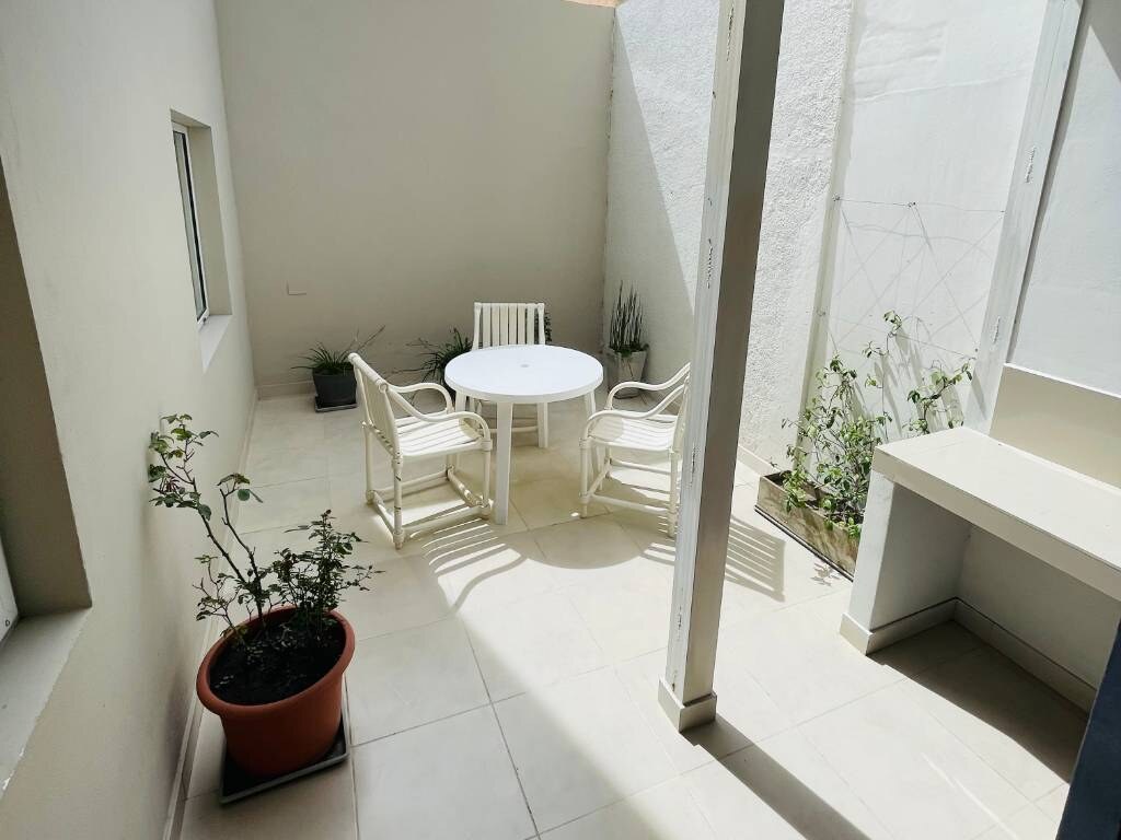 Patio with round table and white chairs